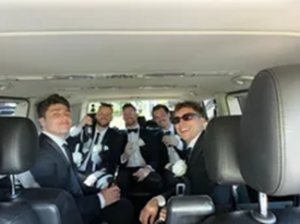 Men in tux arrive in a limousine